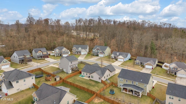 birds eye view of property featuring a residential view and a wooded view