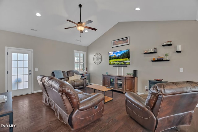 living room featuring dark wood-style flooring, lofted ceiling, visible vents, ceiling fan, and baseboards