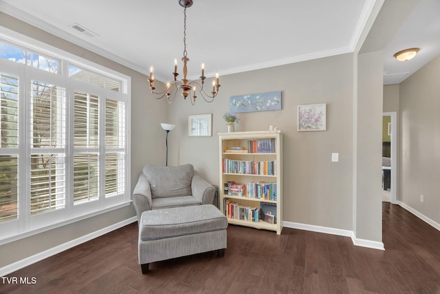 living area featuring crown molding, baseboards, and wood finished floors