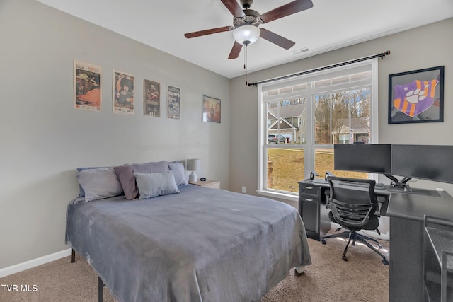 carpeted bedroom featuring ceiling fan, multiple windows, visible vents, and baseboards