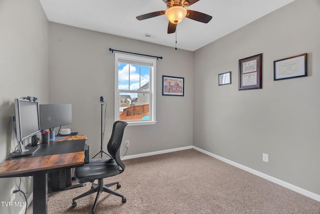 office space featuring carpet floors, visible vents, ceiling fan, and baseboards