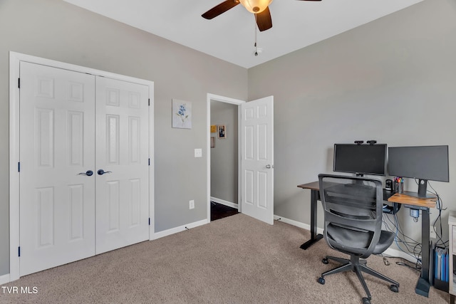 home office featuring carpet, ceiling fan, and baseboards