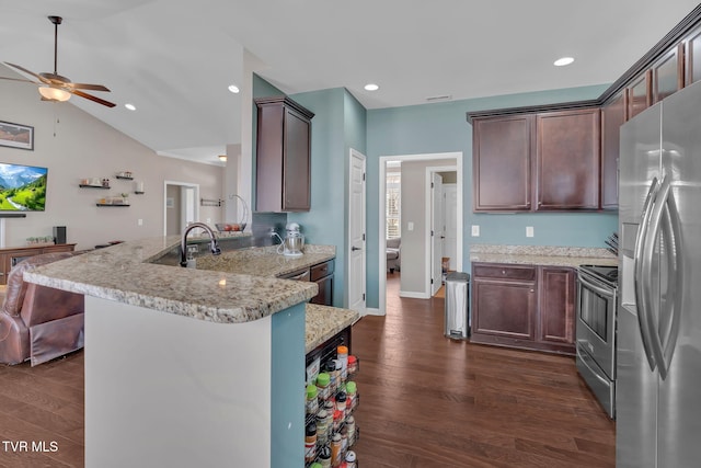 kitchen with a peninsula, appliances with stainless steel finishes, dark wood-style flooring, and recessed lighting