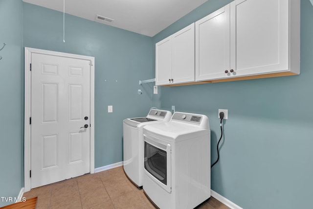 clothes washing area featuring light tile patterned floors, visible vents, cabinet space, independent washer and dryer, and baseboards