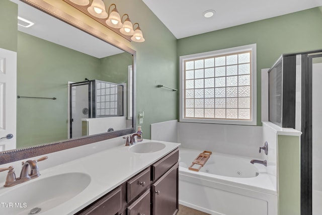 bathroom featuring a sink, a shower stall, a whirlpool tub, and double vanity