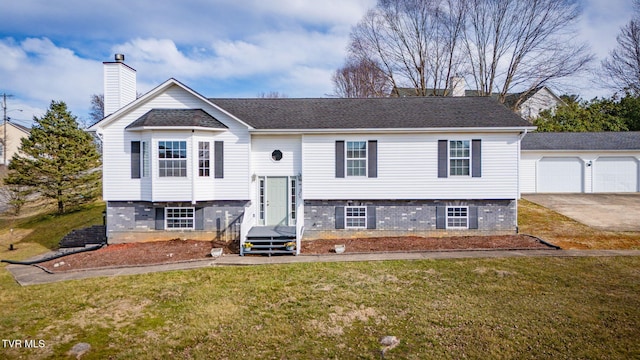 split foyer home with a front yard, roof with shingles, and a chimney