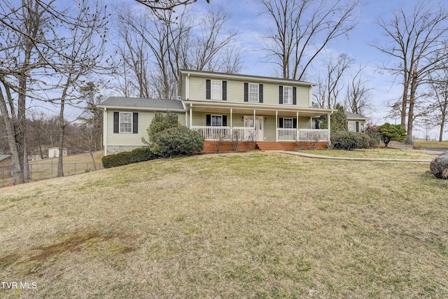 view of front of home with covered porch, fence, and a front yard