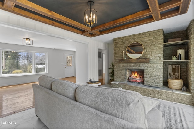 living area with baseboards, coffered ceiling, beamed ceiling, marble finish floor, and a fireplace