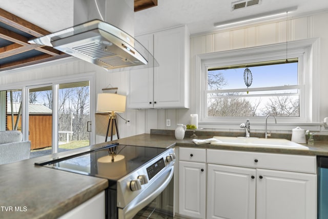 kitchen with a sink, visible vents, a healthy amount of sunlight, stainless steel electric range oven, and wall chimney exhaust hood