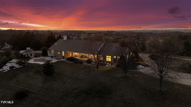 back of property at dusk with a gazebo and a patio