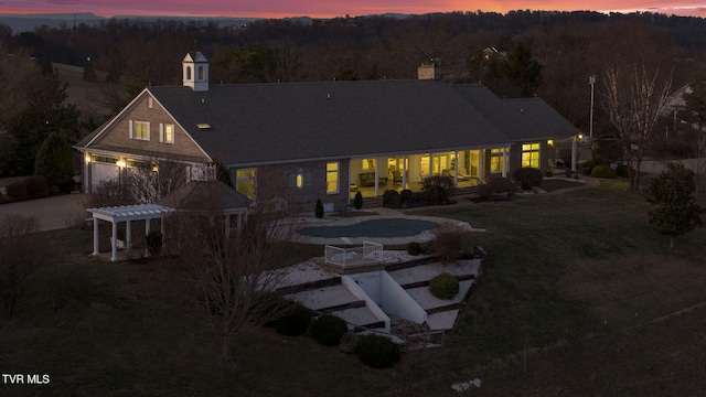 back of house featuring a lawn, a patio area, and a pergola