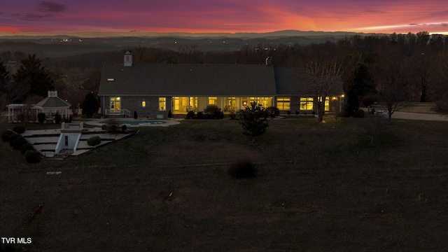 rear view of property with a patio area, a mountain view, and a gazebo