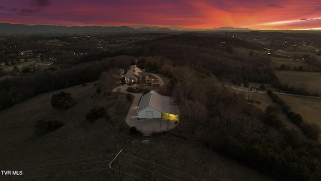 aerial view at dusk featuring a mountain view