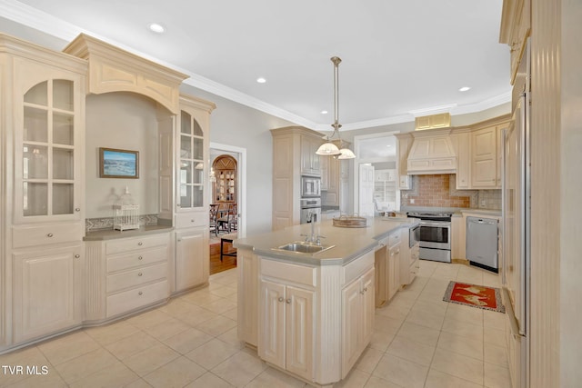 kitchen featuring light tile patterned floors, custom range hood, appliances with stainless steel finishes, a kitchen island with sink, and a sink