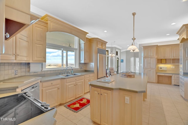 kitchen with a center island, ornamental molding, light brown cabinets, a sink, and paneled refrigerator