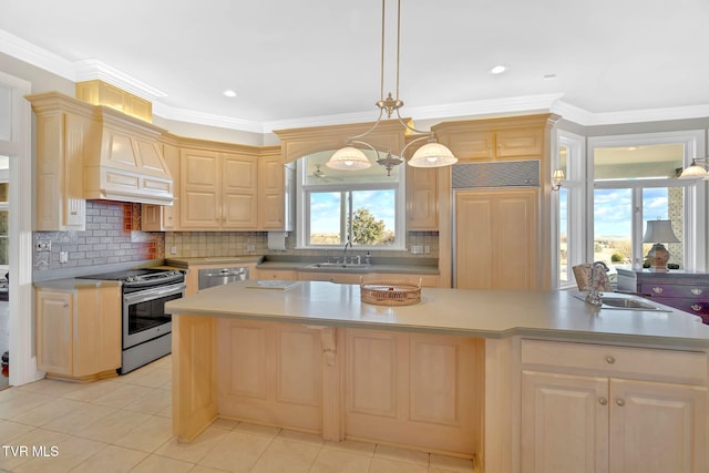 kitchen featuring stainless steel appliances, light brown cabinetry, and a sink