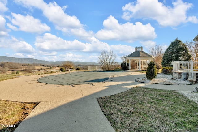 view of yard featuring a patio area, a mountain view, and a gazebo