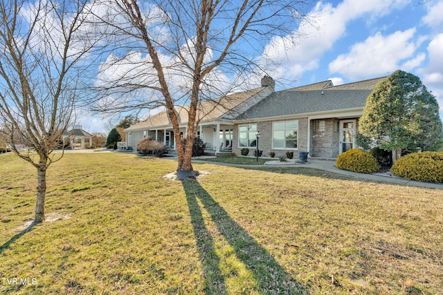 single story home with a gazebo, brick siding, a chimney, and a front lawn