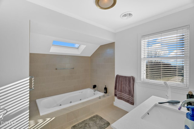 full bath featuring a whirlpool tub, a skylight, visible vents, and a sink