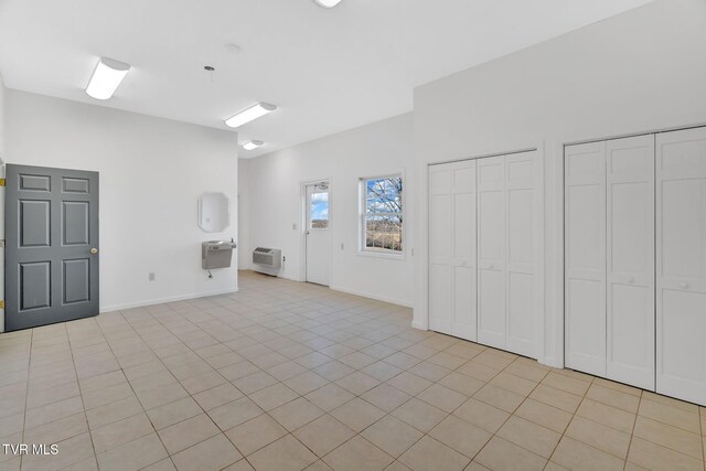 interior space featuring a wall mounted AC and baseboards