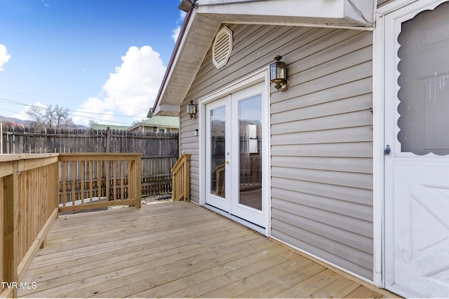 wooden deck featuring fence and french doors