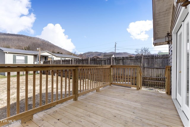 deck with fence private yard and a mountain view