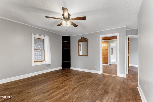 interior space featuring crown molding, a textured ceiling, baseboards, and dark wood-style flooring