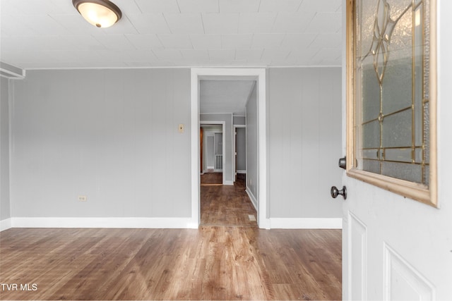 interior space with wood finished floors and baseboards