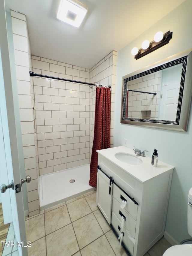 full bathroom featuring tile patterned floors, a shower stall, vanity, and toilet