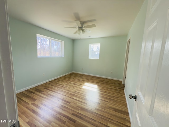 unfurnished bedroom featuring ceiling fan, baseboards, and wood finished floors