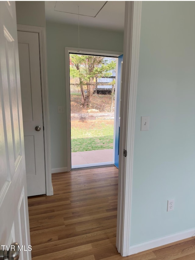 entryway featuring baseboards and wood finished floors