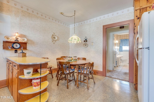 dining area with wallpapered walls and baseboards