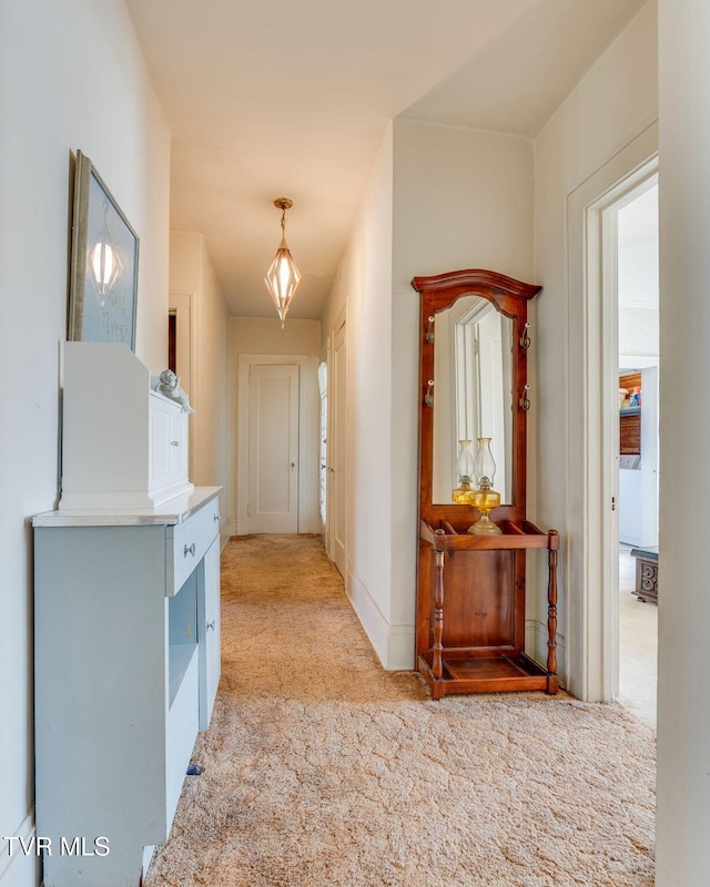 hallway featuring light carpet