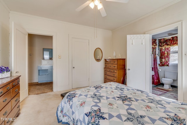 bedroom featuring light carpet, ensuite bath, crown molding, and ceiling fan