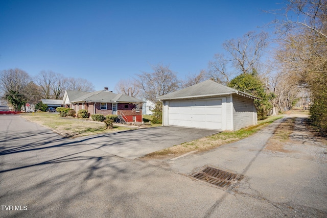 view of front of home featuring a detached garage and an outbuilding