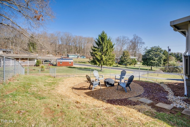 view of yard featuring fence and a fire pit