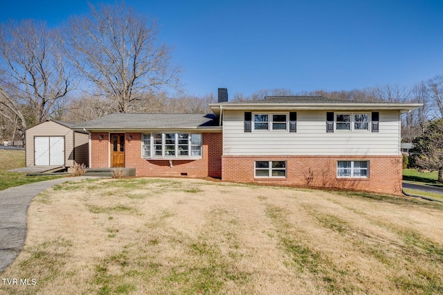 tri-level home featuring an outbuilding, a chimney, a front lawn, and a storage unit