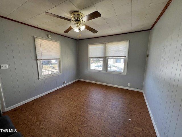 unfurnished room featuring ceiling fan, ornamental molding, and baseboards