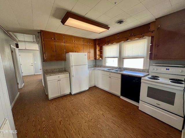 kitchen featuring open shelves, light countertops, visible vents, a sink, and white appliances