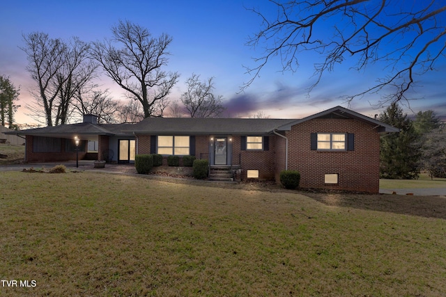 single story home with brick siding, crawl space, and a lawn