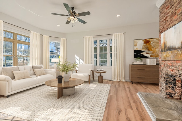 sitting room featuring a ceiling fan, recessed lighting, a healthy amount of sunlight, and light wood-type flooring