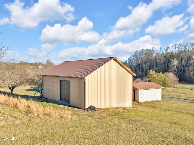 view of pole building with a yard and driveway