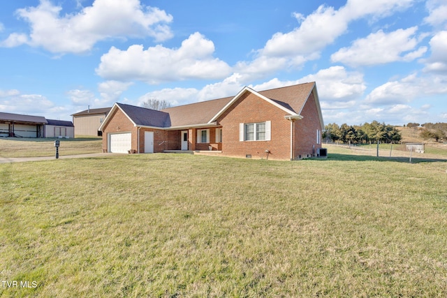 ranch-style home featuring a garage, brick siding, a front yard, and central air condition unit