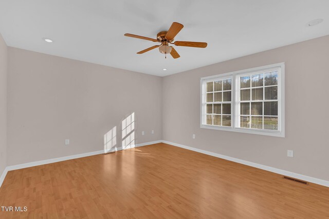 spare room with baseboards, visible vents, ceiling fan, wood finished floors, and recessed lighting