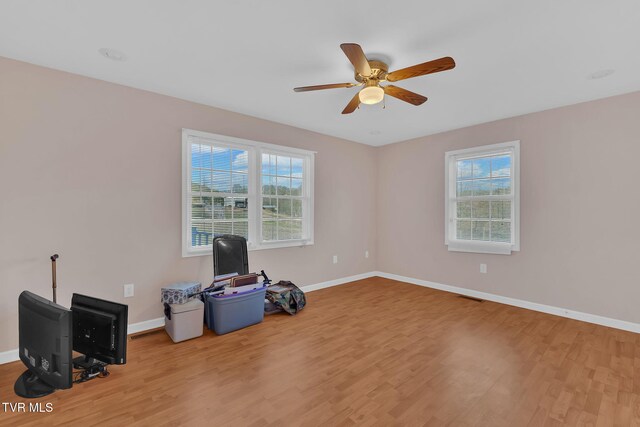 miscellaneous room with baseboards and wood finished floors