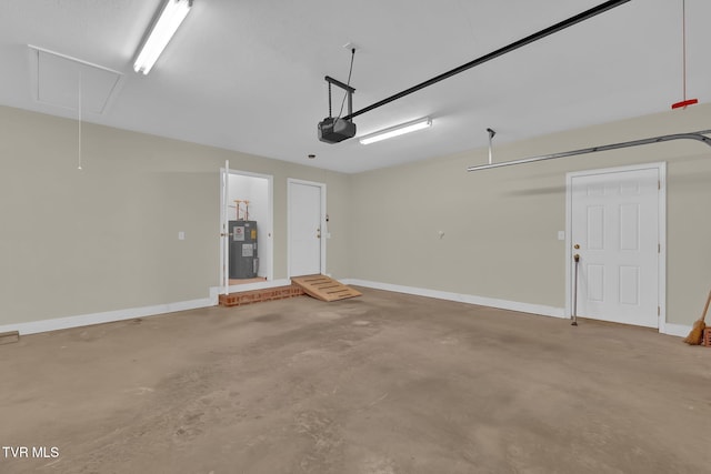 garage featuring a garage door opener, water heater, and baseboards