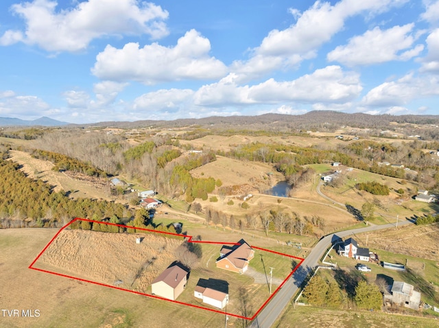 drone / aerial view featuring a rural view and a mountain view