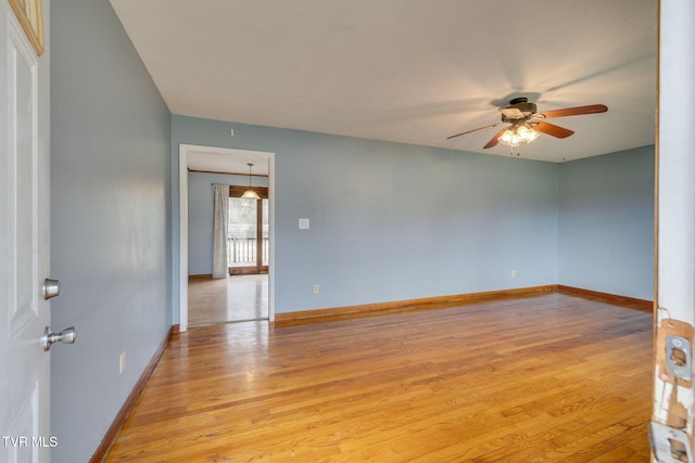 unfurnished room with light wood-type flooring, baseboards, and a ceiling fan