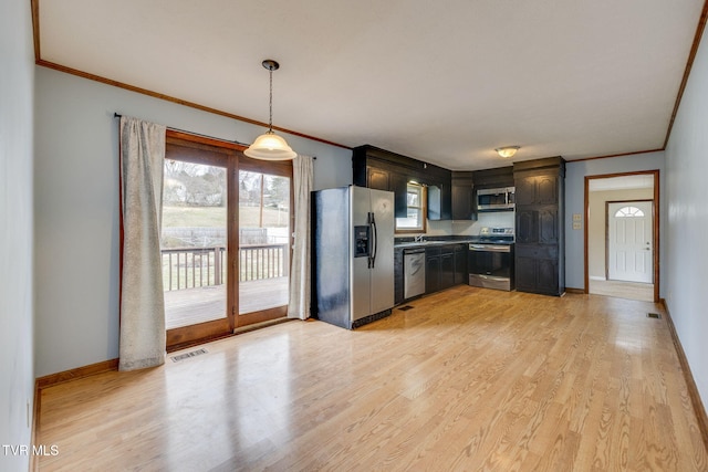 kitchen featuring appliances with stainless steel finishes, visible vents, and light wood-style flooring