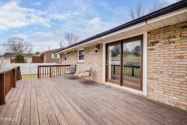 wooden terrace featuring fence